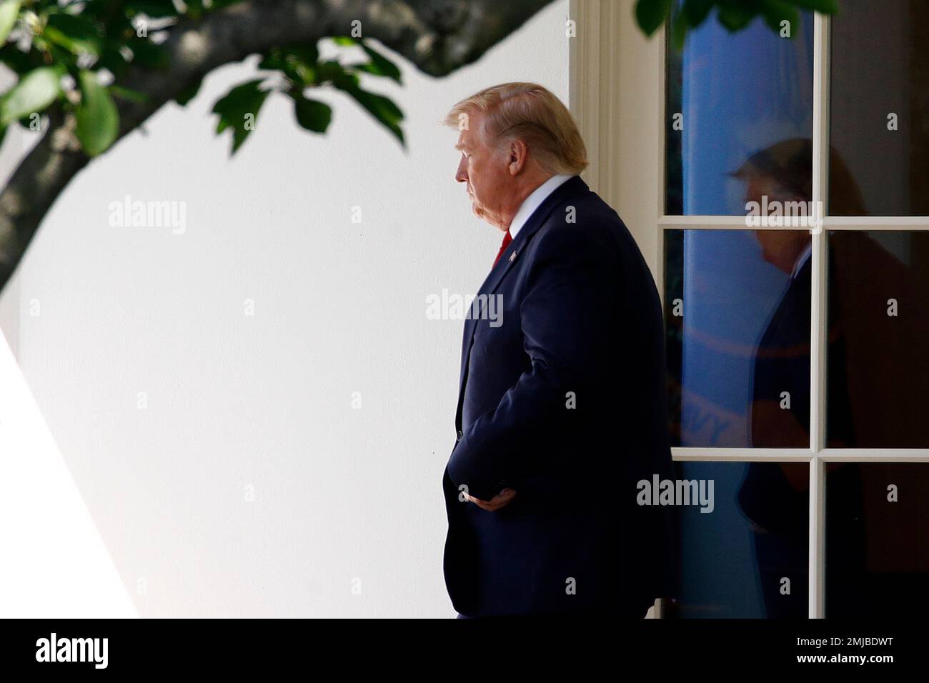 President Donald Trump walks out of the Oval Office to speak with ...