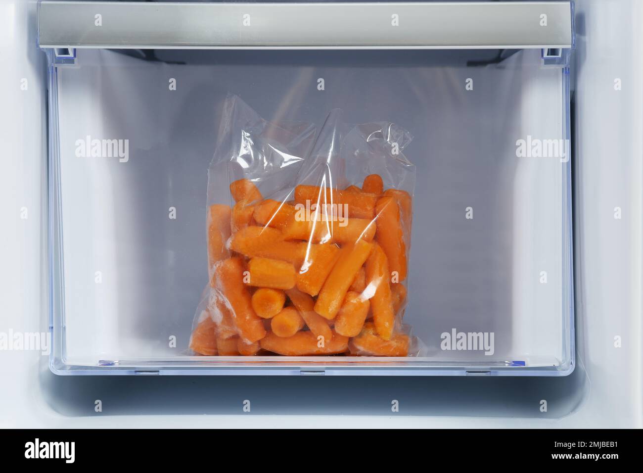 Pack of carrot on drawer of refrigerator Stock Photo