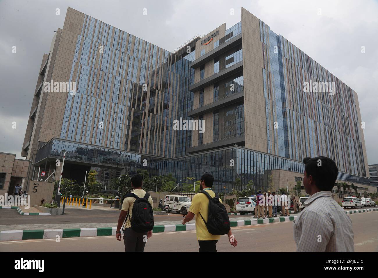 Indian employees walk in the premises of Amazon's newly inaugurated