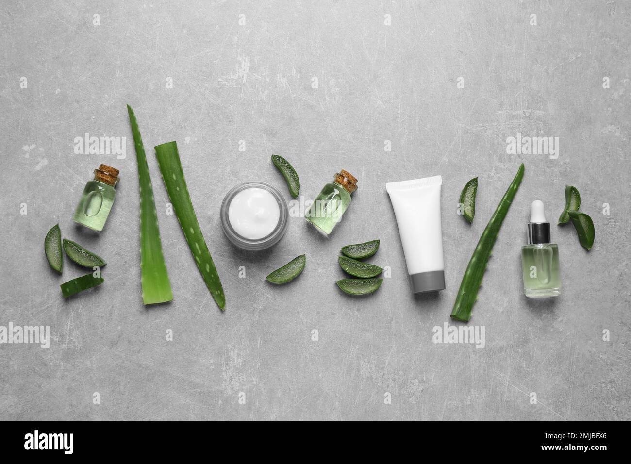 Flat lay composition with aloe vera and cosmetic products on grey ...