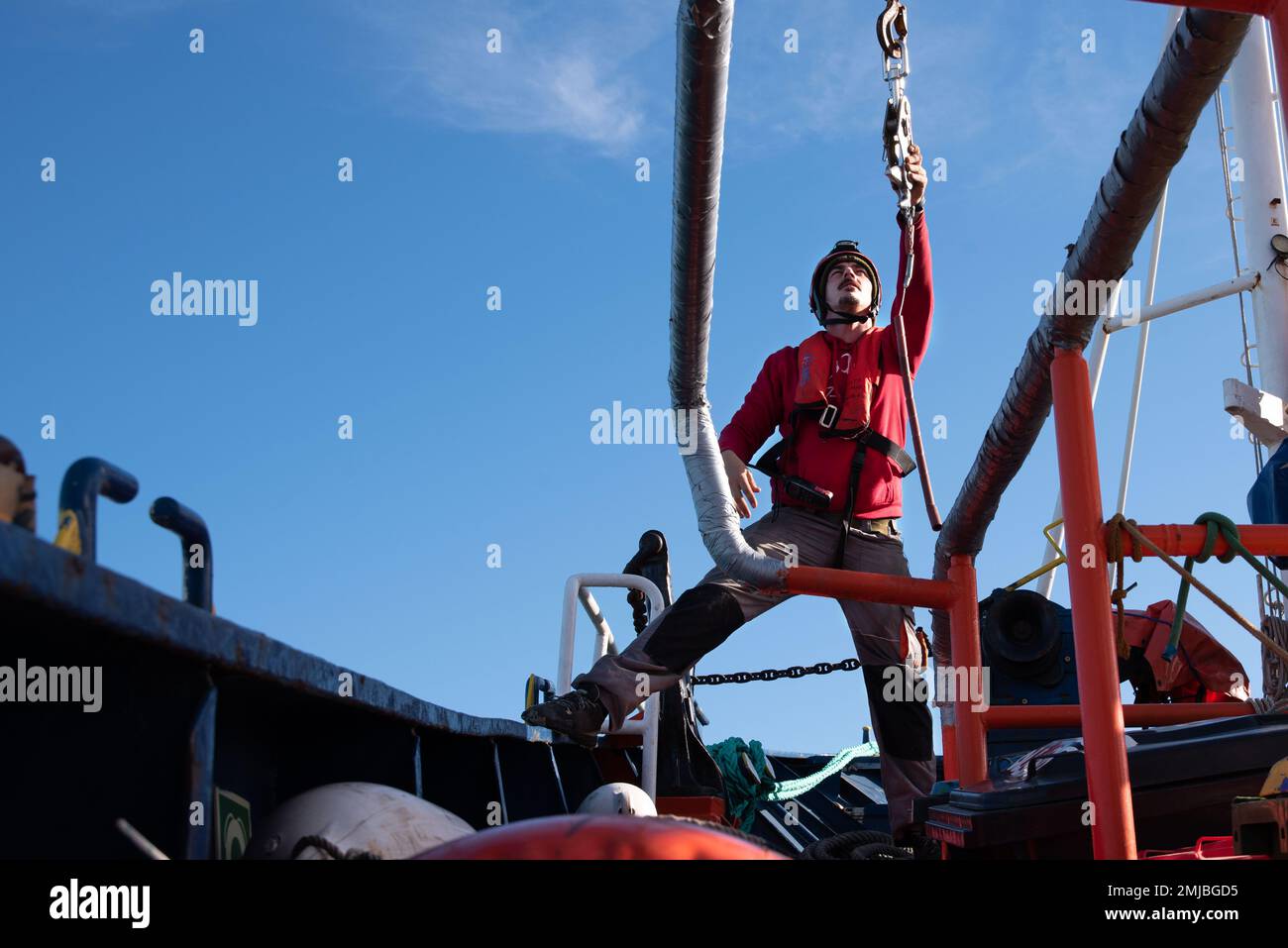 Vinaros, Spain. 27th Jan, 2023. The Aita Mari's first officer on deck maneuvers to lower the rescue boat from the bow of the ship into the water. The maritime rescue NGO SMH is preparing with its ship Aita Mari to go on the first mission of 2023 at the port of Vinarós in the city of Valencia, expectant of the Italian government's obstacles for humanitarian NGOs. Credit: SOPA Images Limited/Alamy Live News Stock Photo