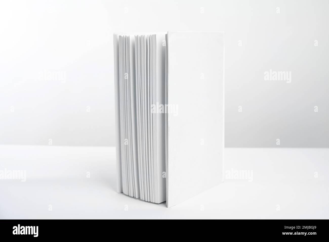 Book with blank cover on white background Stock Photo - Alamy
