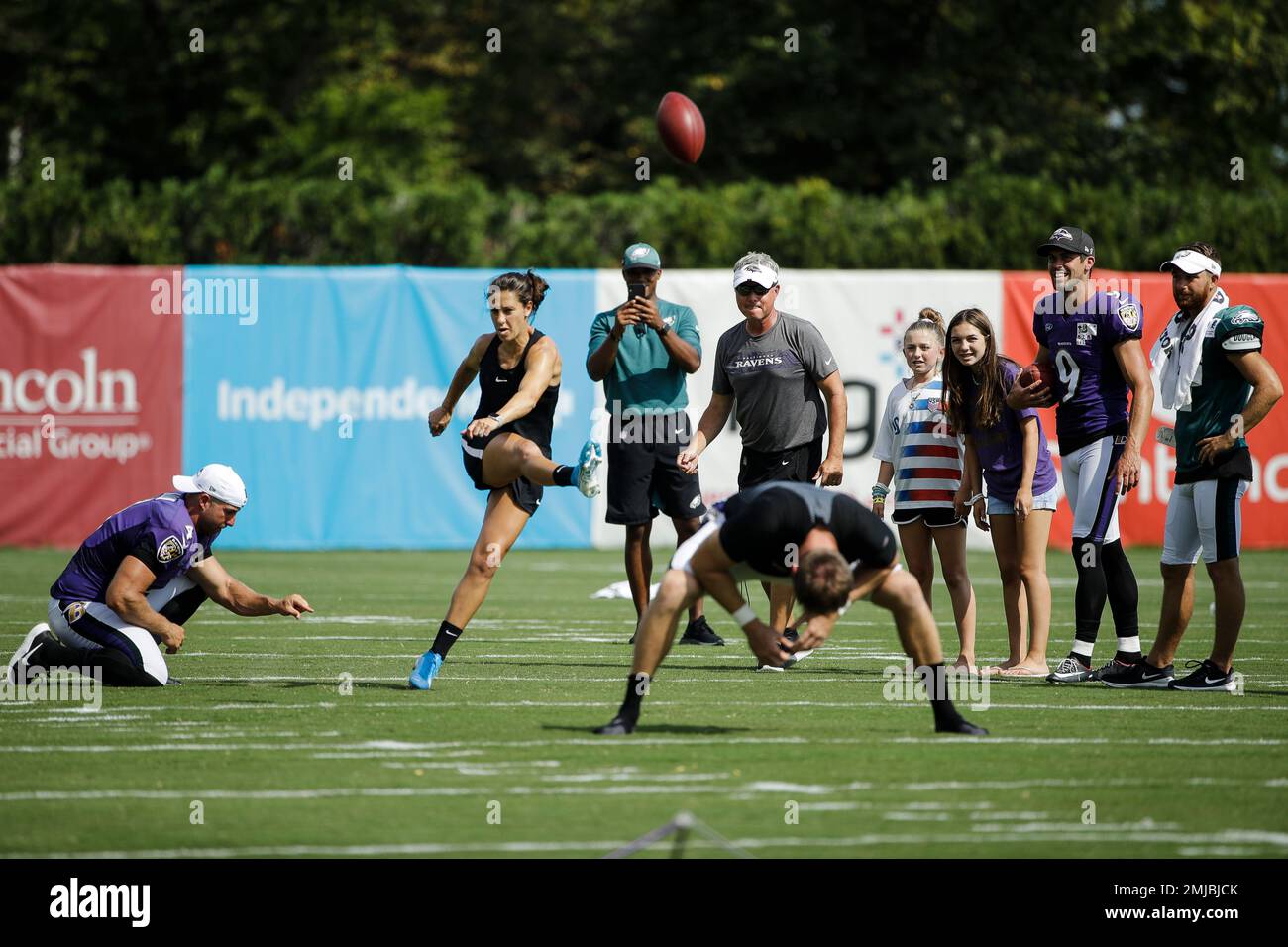 United States soccer player Carli Lloyd attempts to kick a field goal