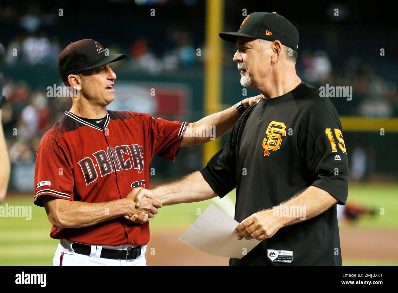 Arizona Diamondbacks manager Torey Lovullo, left, presents San