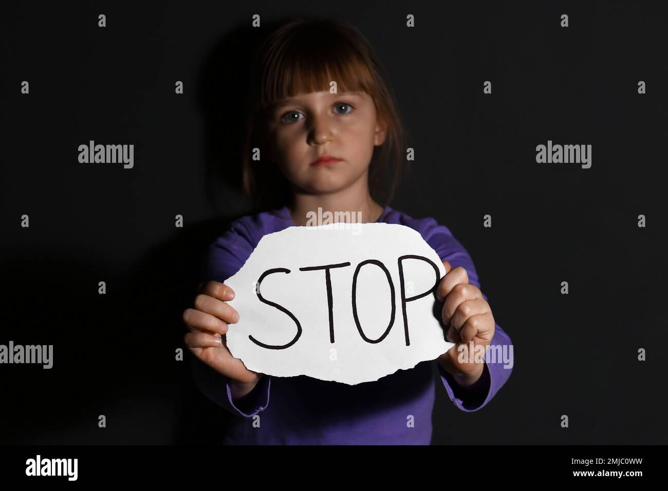 Abused Little Girl With Sign STOP Near Black Wall. Domestic Violence ...