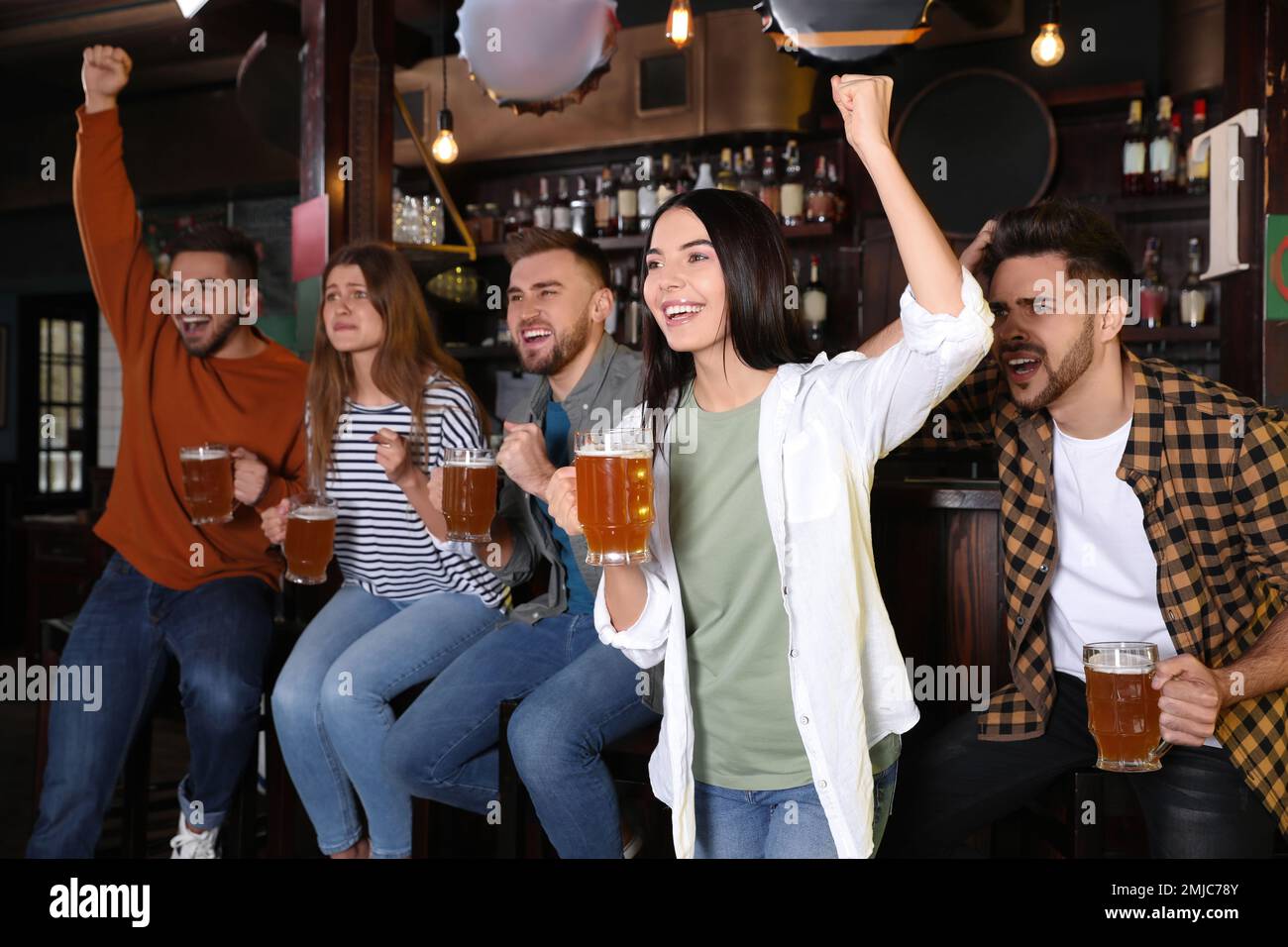 Group of friends watching football in sport bar Stock Photo Alamy