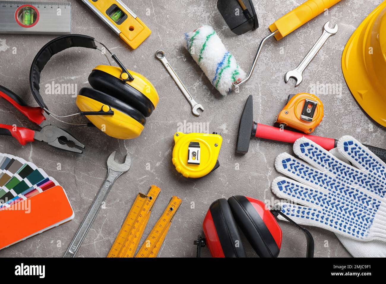 Flat lay composition with different construction tools on grey marble ...