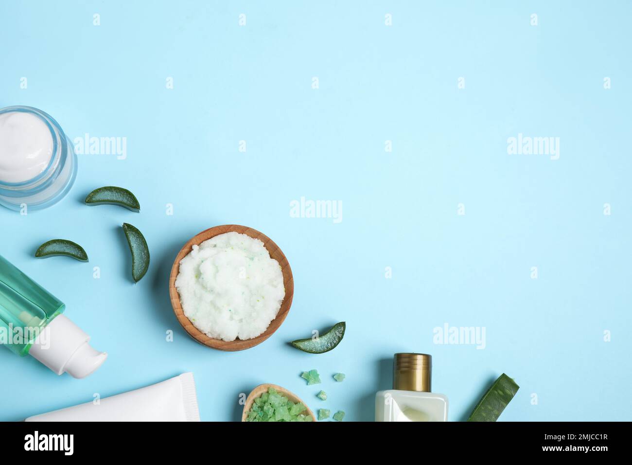 Flat lay composition with aloe vera and cosmetic products on light blue ...