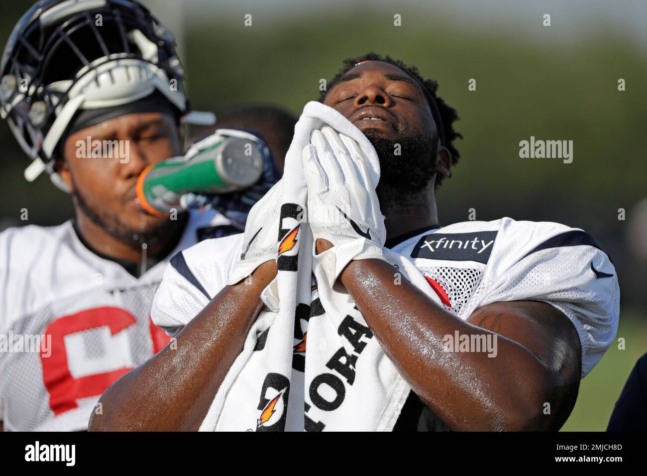 Houston Texans nose tackle Brandon Dunn wipes his face during a joint