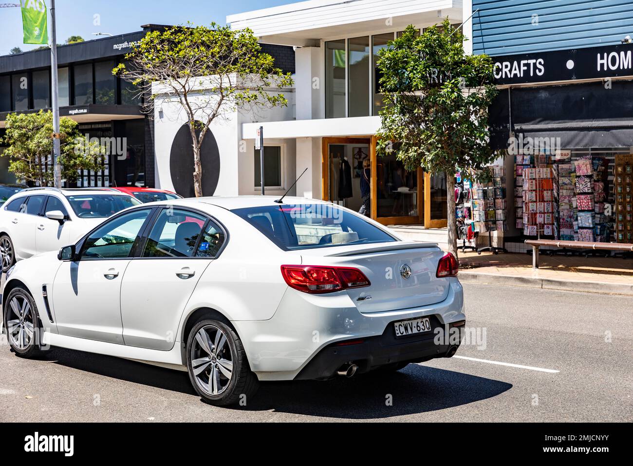 White Holden Commodore saloon car driving on the road in Sydney