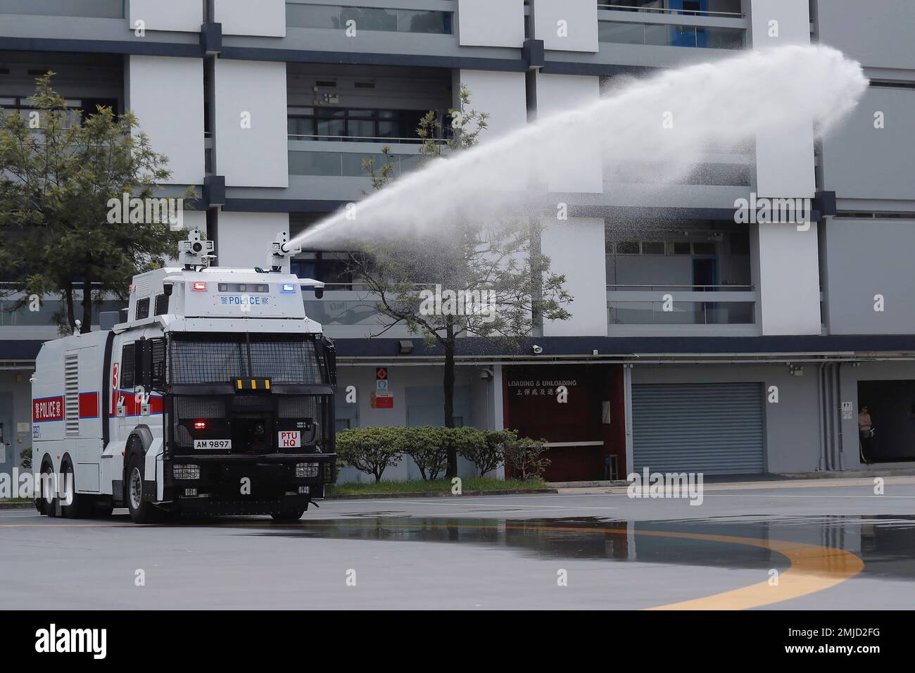 An anti-riot vehicle equipped with water cannon sprays water during a ...