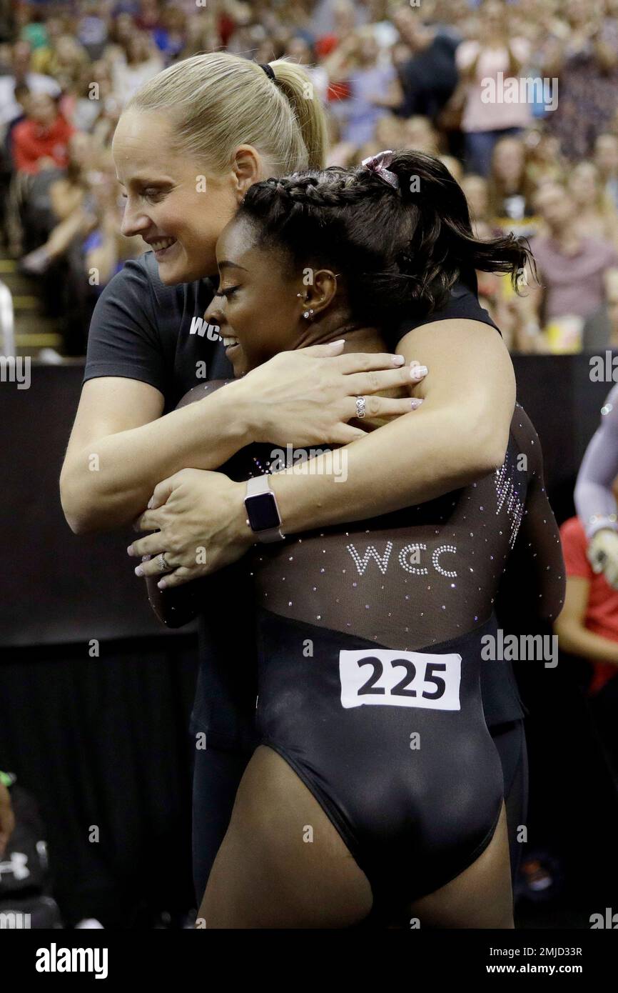 Simone Biles hugs her coach Cecile CanqueteauLandi after competing in