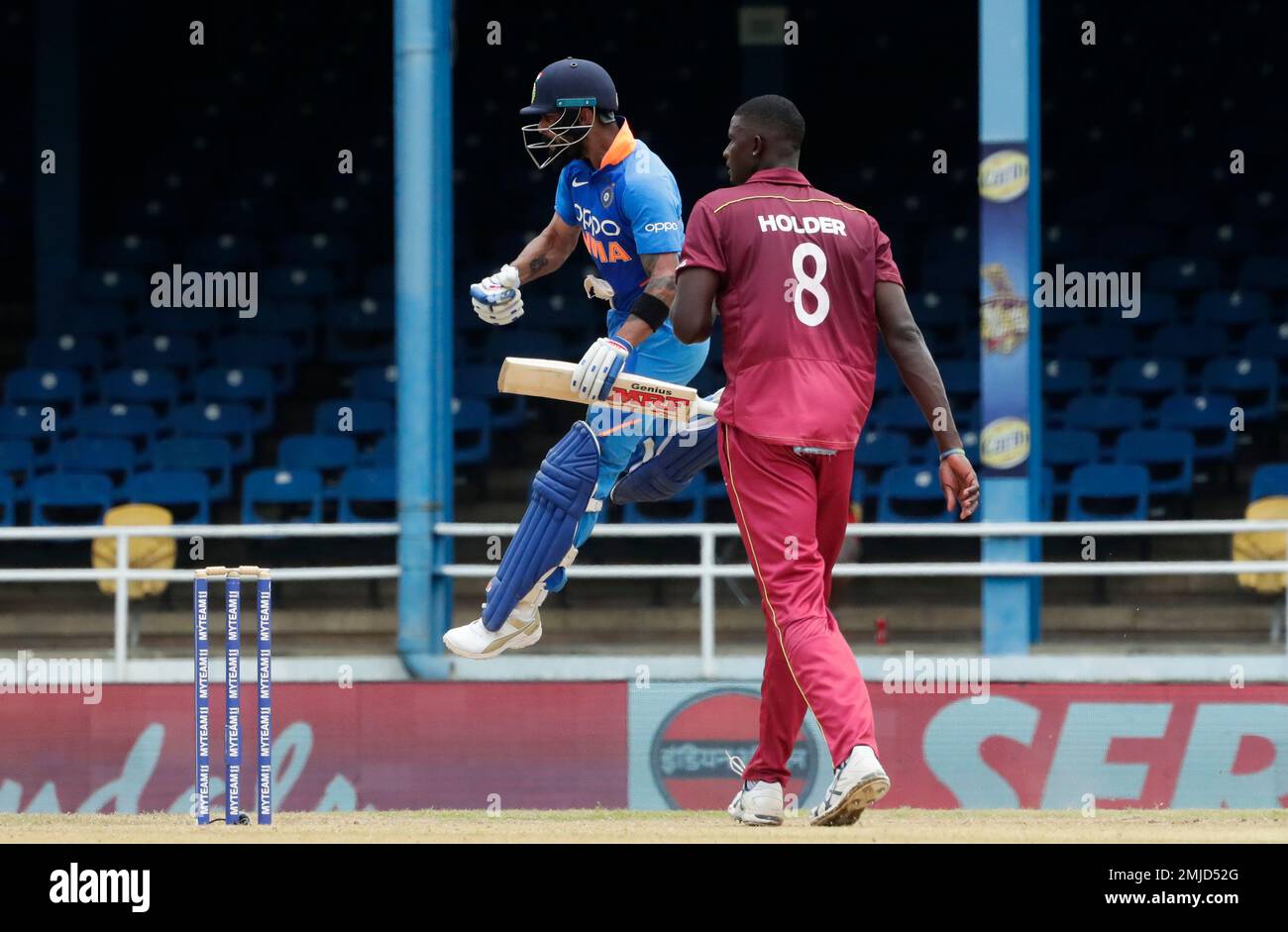 India's captain Virat Kohli jumps into the air while celebrating his century as West Indies