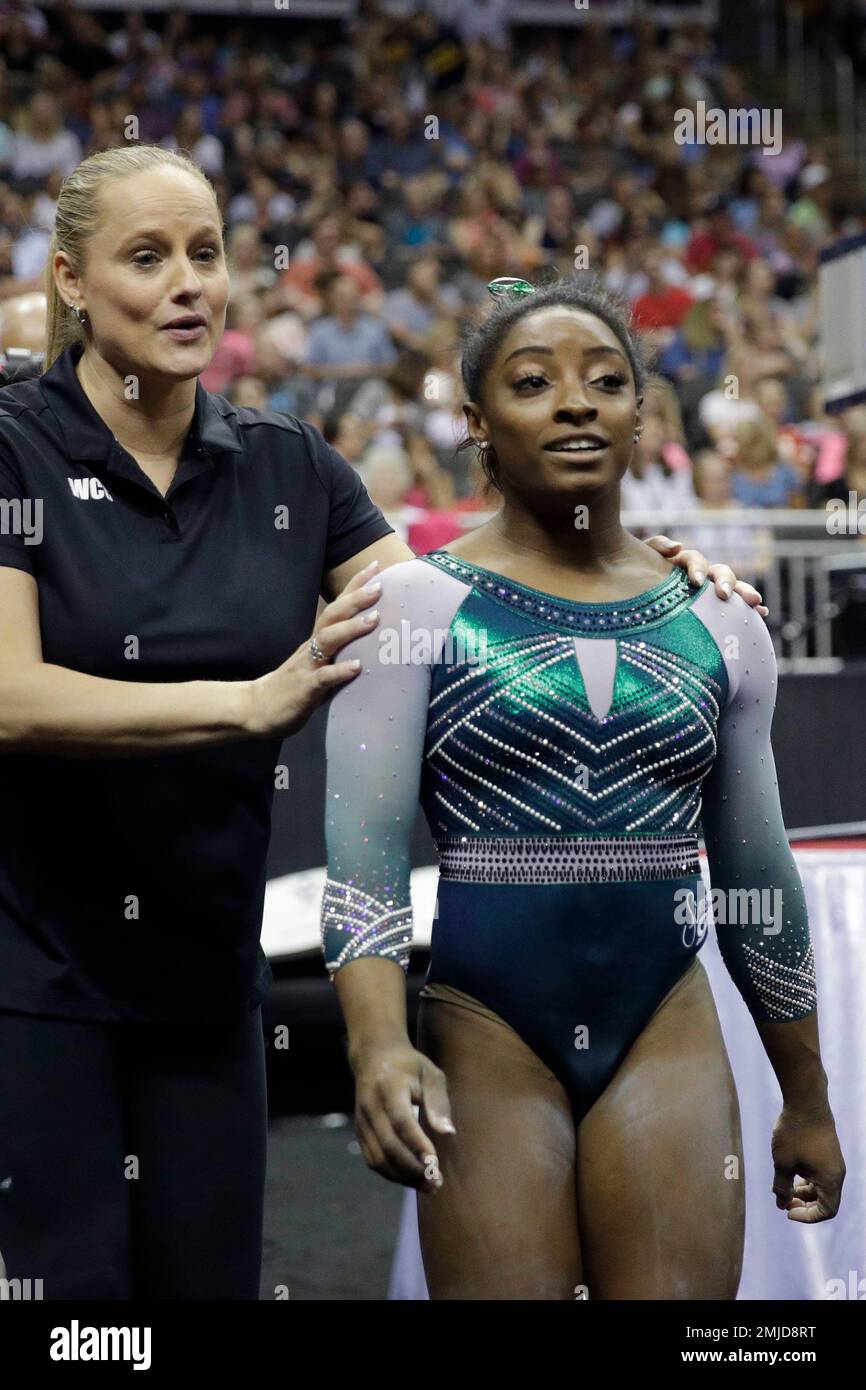 Simone Biles walks with her coach Cecile CanqueteauLandi after