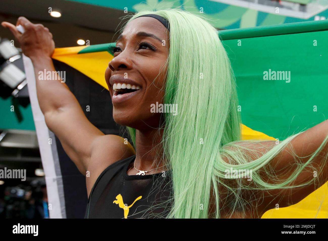 ShellyAnn FraserPryce ofJamaica celebrates winning the gold medal in the women