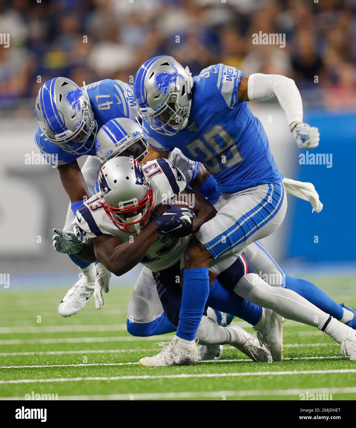 New England Patriots wide receiver Phillip Dorsett (13) is tackled by  Detroit Lions cornerback Jamal Agnew (39), defensive back Tracy Walker (47)  and cornerback Justin Coleman during the first half of a