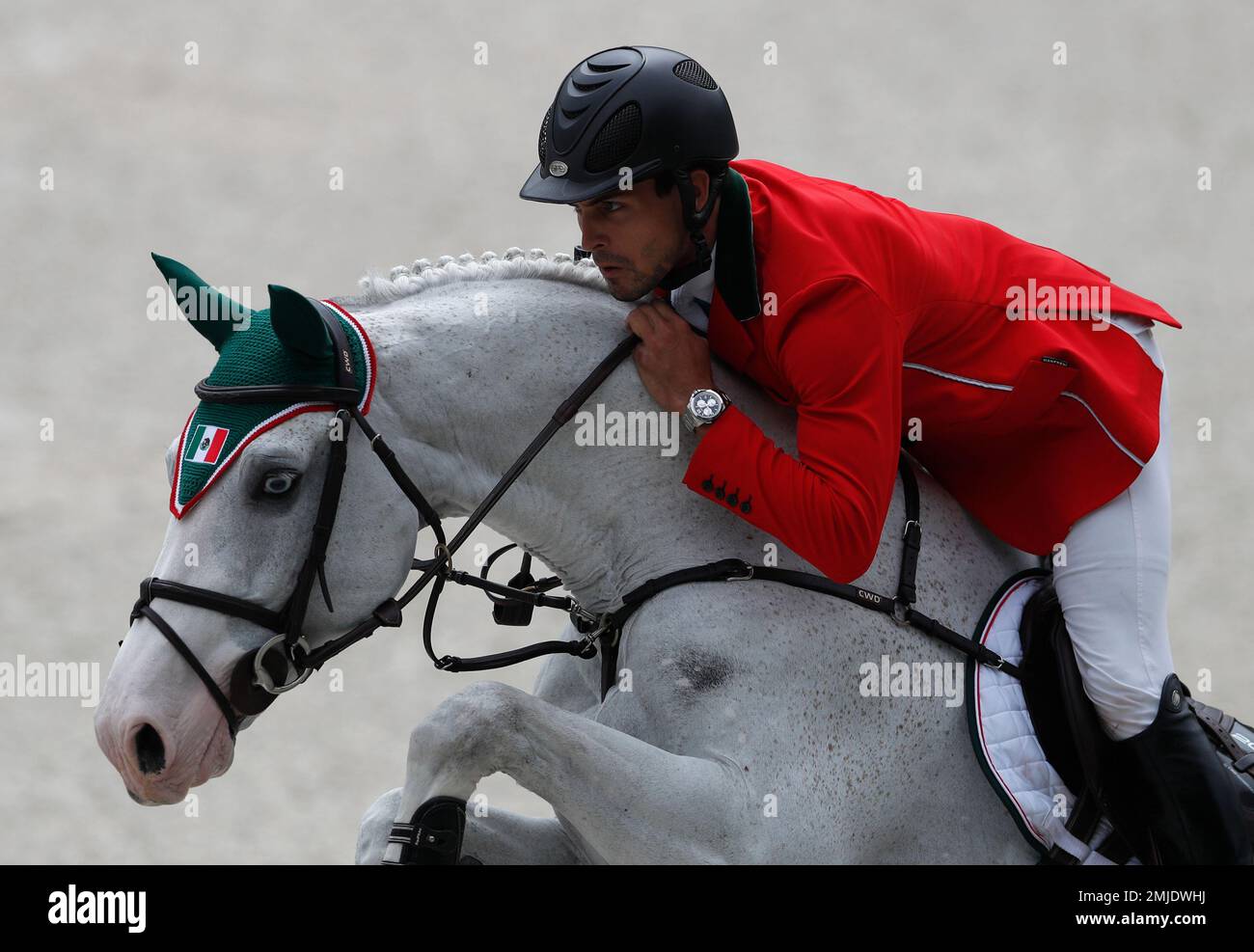 Mexicos Eugenio Garza Perez takes a jump on his horse Armani SI Z as he competes in the first classification round of individual and team equestrian jumping at the Pan American Games