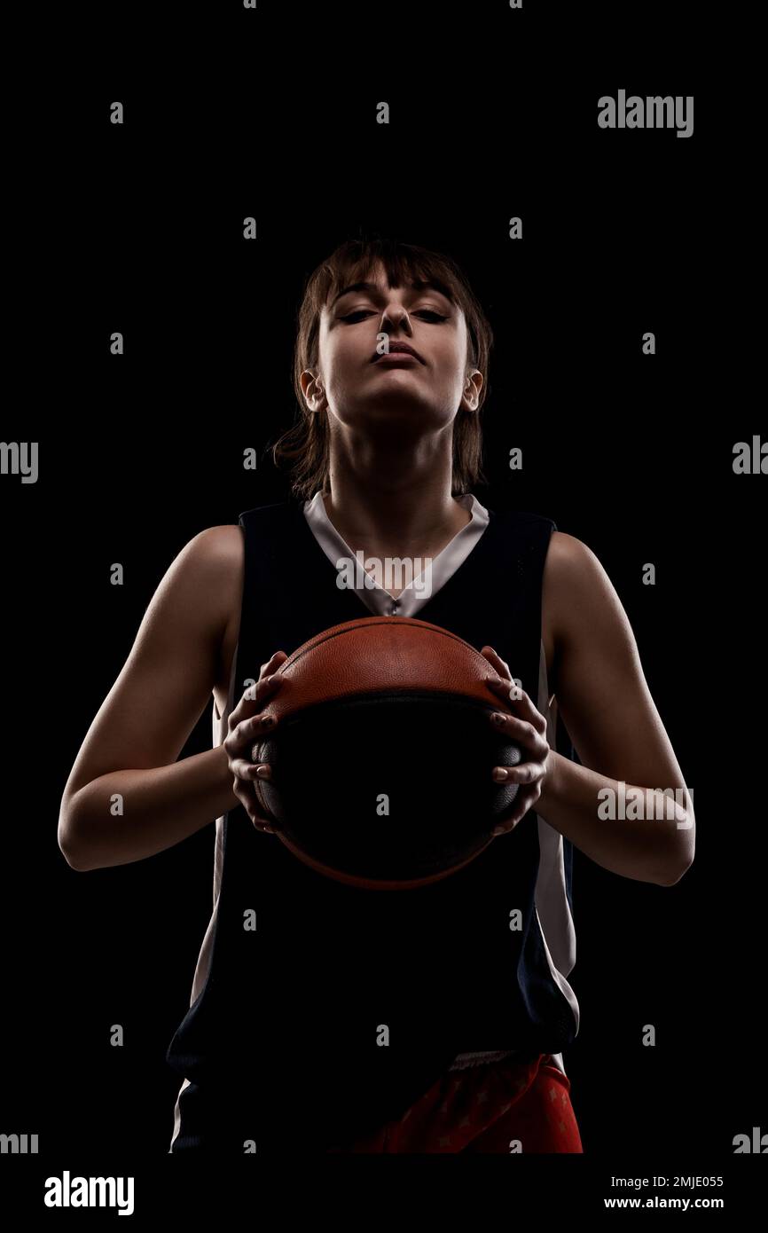 Female Basketball Player Beautiful Girl Holding Ball Side Lit Half Silhouette Studio Portrait