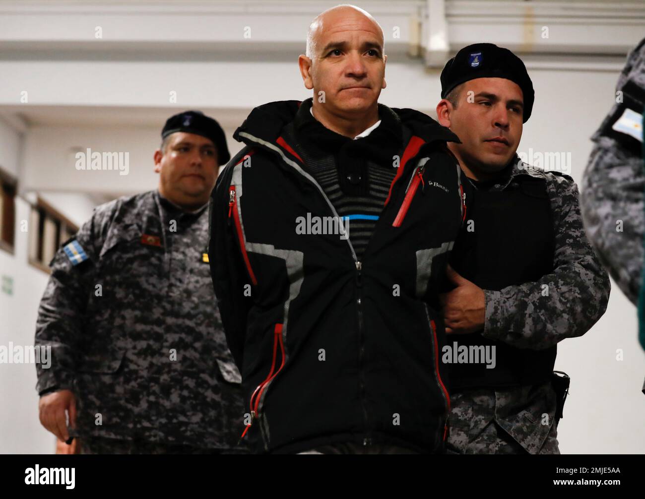 Armando Gomez is escorted from a courtroom after attending the first day of his trial in Mendoza, Argentina, Monday, Aug. 5, 2019. Gomez, 63, and two Roman Catholic priests are being tried for cases of alleged abuse against ex-students at the Antonio Provolo Institute for Deaf and Hearing Impaired Children in Mendoza province. (AP Photo/Natacha Pisarenko) Stock Photo