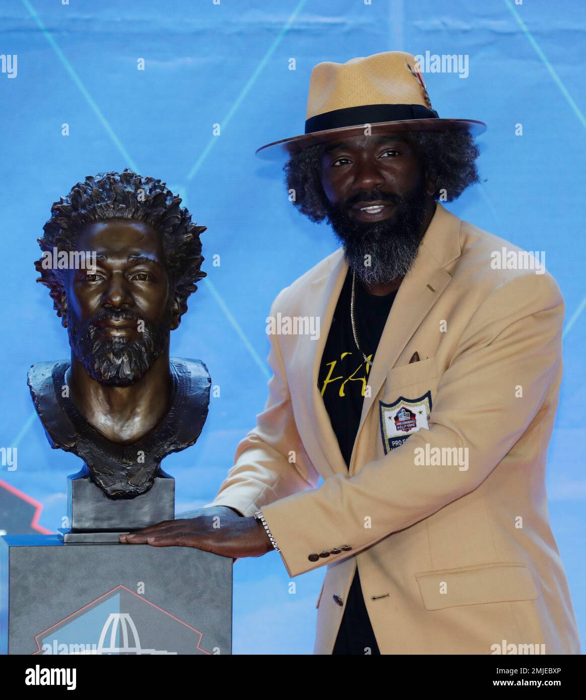 Former NFL player Ed Reed poses with a bust of himself during the induction  ceremony at the Pro Football Hall of Fame, Saturday, Aug. 3, 2019, in  Canton, Ohio. (AP Photo/Ron Schwane
