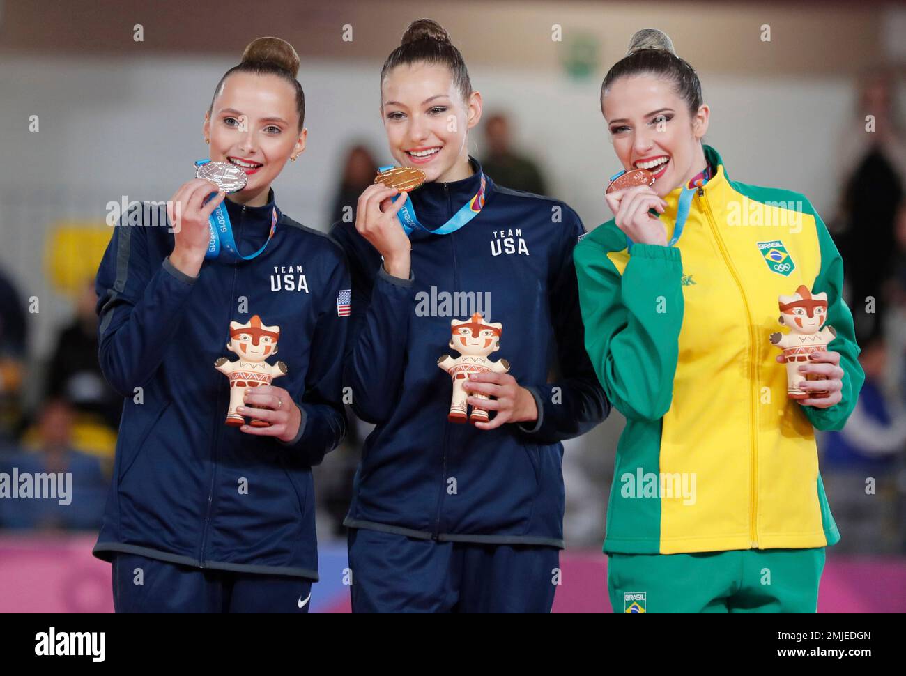 Camila Freeley of the United States, left, Evita Griskenas of the United  States and Natalia Gaudio of Brazil poses with their medals at the podium  during the rhythmic gymnastics individual all around