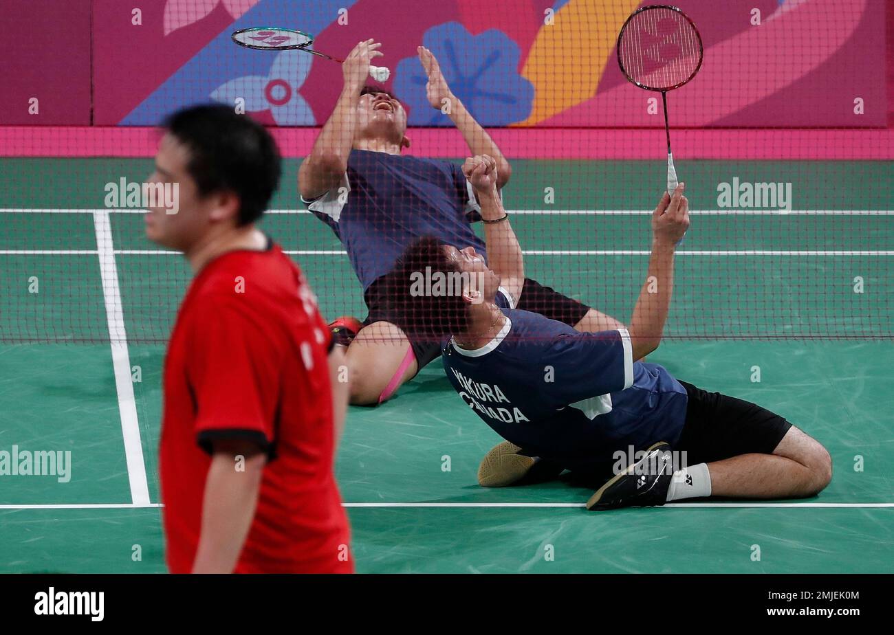 Jason Ho-Shue, top center, and Nyl Yakura of Canada, right, celebrate their  gold medal badminton win in the men's doubles against Phillip Chew and Ryan  Chew of the United States, at at