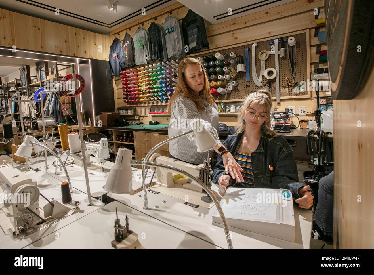 In this June 14, 2019, photo Sue Ceccarelli, left, Vice President of Retail  Operations for Levi Strauss & Co.. talks with with tailor Aly Reinert in  the Levi's Tailor Shop, in the