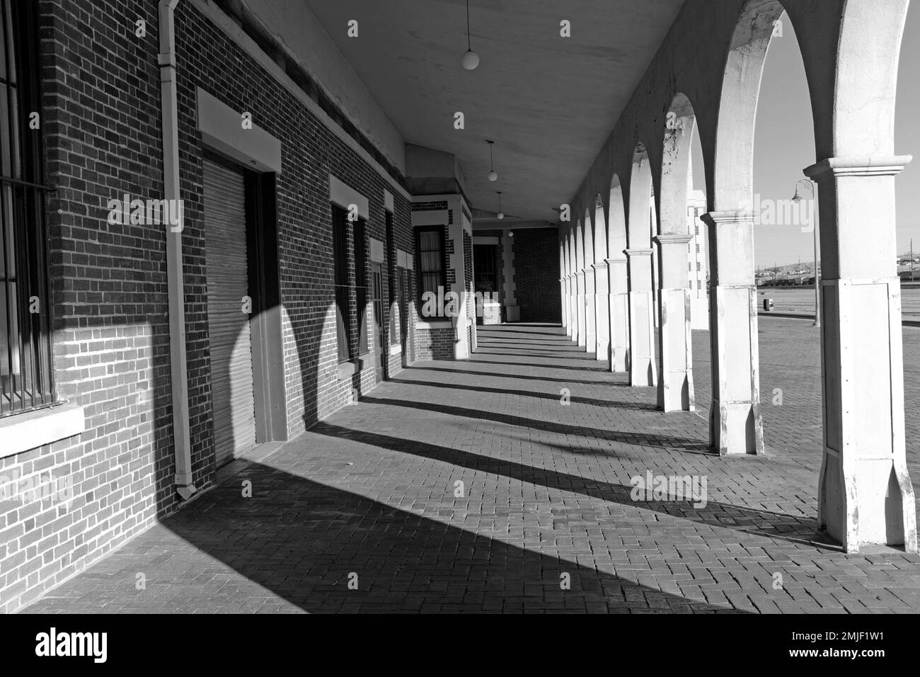 An empty colonnade at the historic Harvey House Hotel, known as Casa del Desierto, now an Amtrak station and home to several organizations. Stock Photo