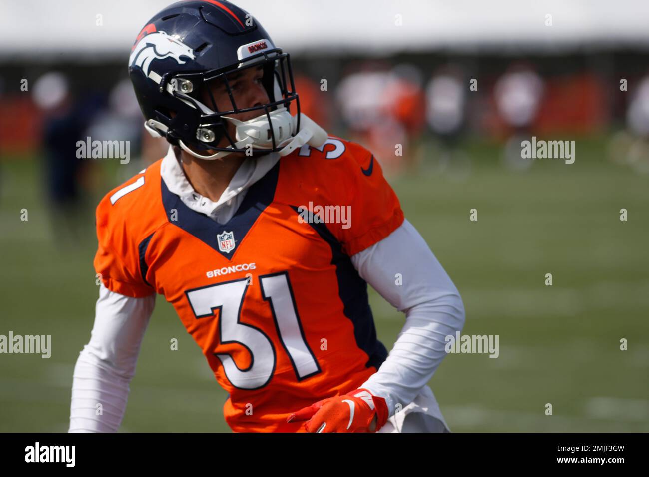 Denver Broncos free safety Justin Simmons takes off his jersey to meet  coronavirus requirements after taking part in drills at NFL football  training camp, Wednesday, July 28, 2021, in Englewood, Colo. (AP