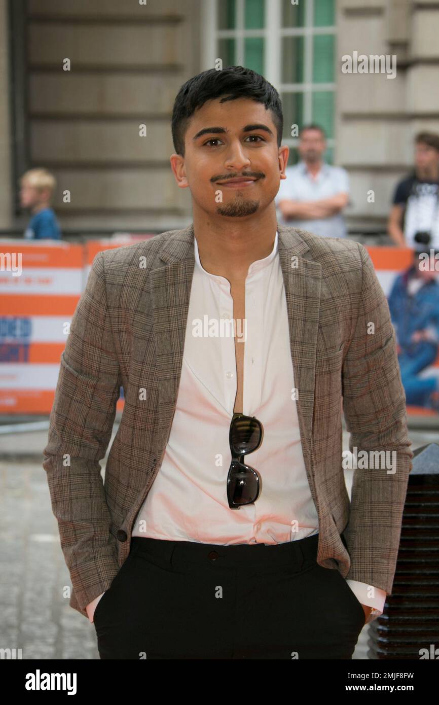 Aaron Phagura poses for photographers upon arrival at the screening for ...