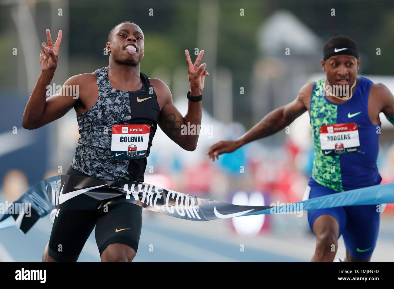 Christian Coleman celebrates in front of Michael Rodgers, right, as he ...