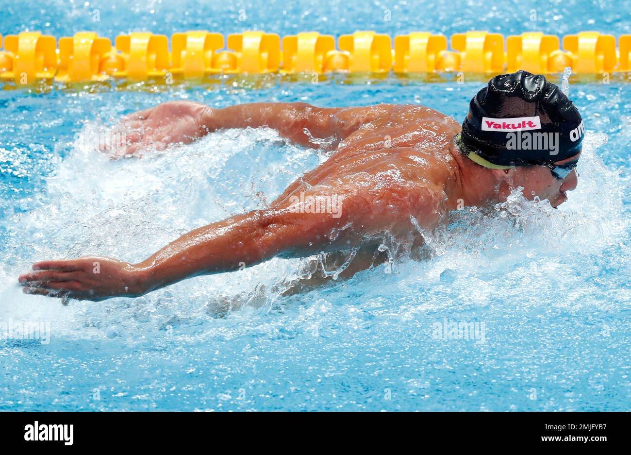 Syria's Ayman Kelzi swims in his heat of the men's 100m butterfly at