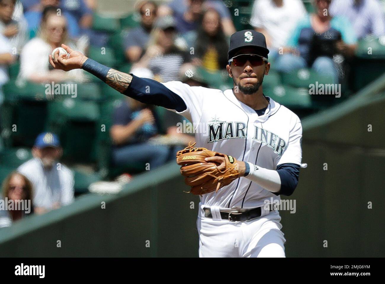Seattle Mariners shortstop J.P. Crawford throws to first to get