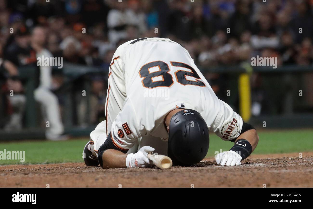 San Francisco Giants' Buster Posey reacts after being hit by a pitch ...