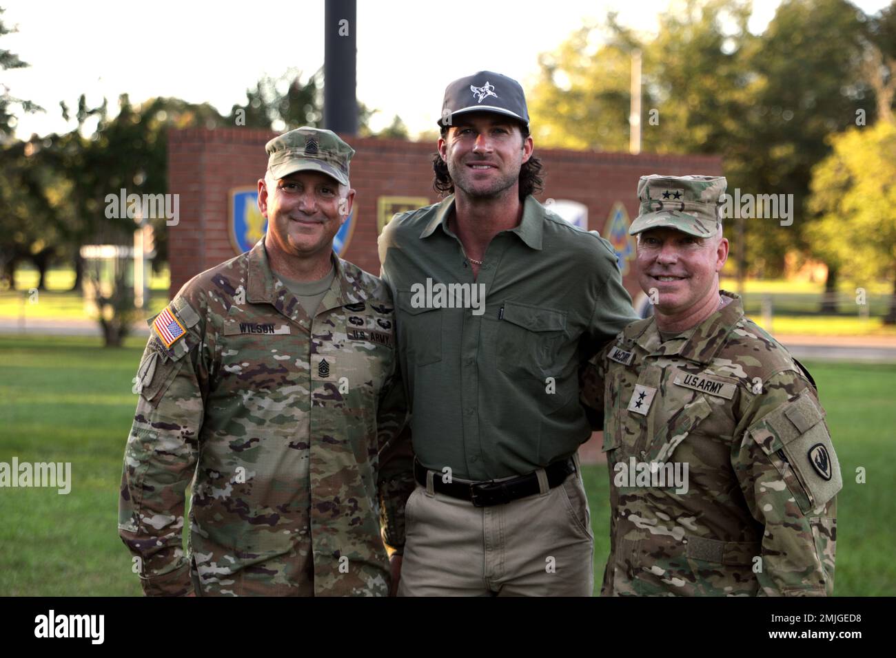 Maj. Gen. Michael McCurry, U.S. Army Aviation Center of Excellence and Fort Rucker commander, and Command Sgt. Maj. James D. Wilson, U.S. Army aviation branch command sergeant major, stand with country music singer Riley Green at Fort Rucker, Alabama, August 29, 2022. Stock Photo
