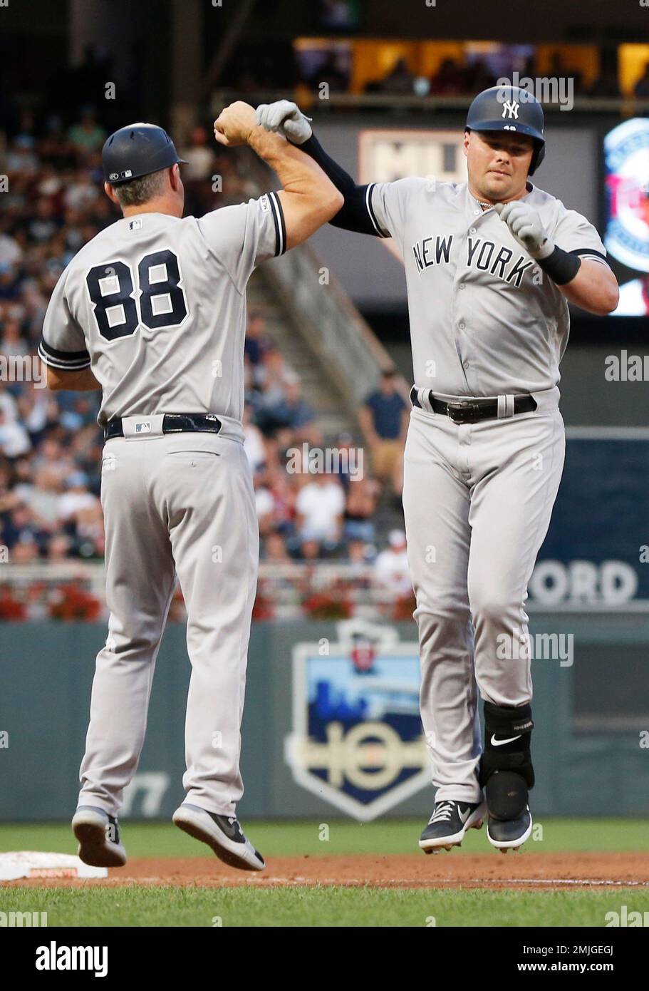 New York Yankees' Mike Tauchman, right, is congratulated by third base  coach Phil Nevin after his solo home run off Minnesota Twins pitcher Martin  Perez in the fourth inning of a baseball