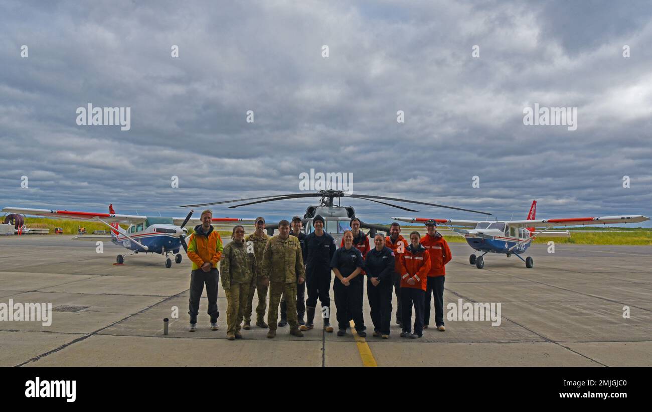 Three Civil Air Patrol Pilots, three Alaska Army National Guard aircrew members and six Coast Guard Marine Safety Task Force members from Coast Guard Sector Anchorage take a moment for a group photo in Bethel Alaska, August 29, 2022. Teams comprised of six Coast Guard marine inspectors visited a total of 20 communities and inspected approximately 50 bulk fuel storage facilities August 22-30, with transportation from Bethel to more remote communities provided by three Alaska Army National Guard members and three Civil Air Patrol pilots. Stock Photo