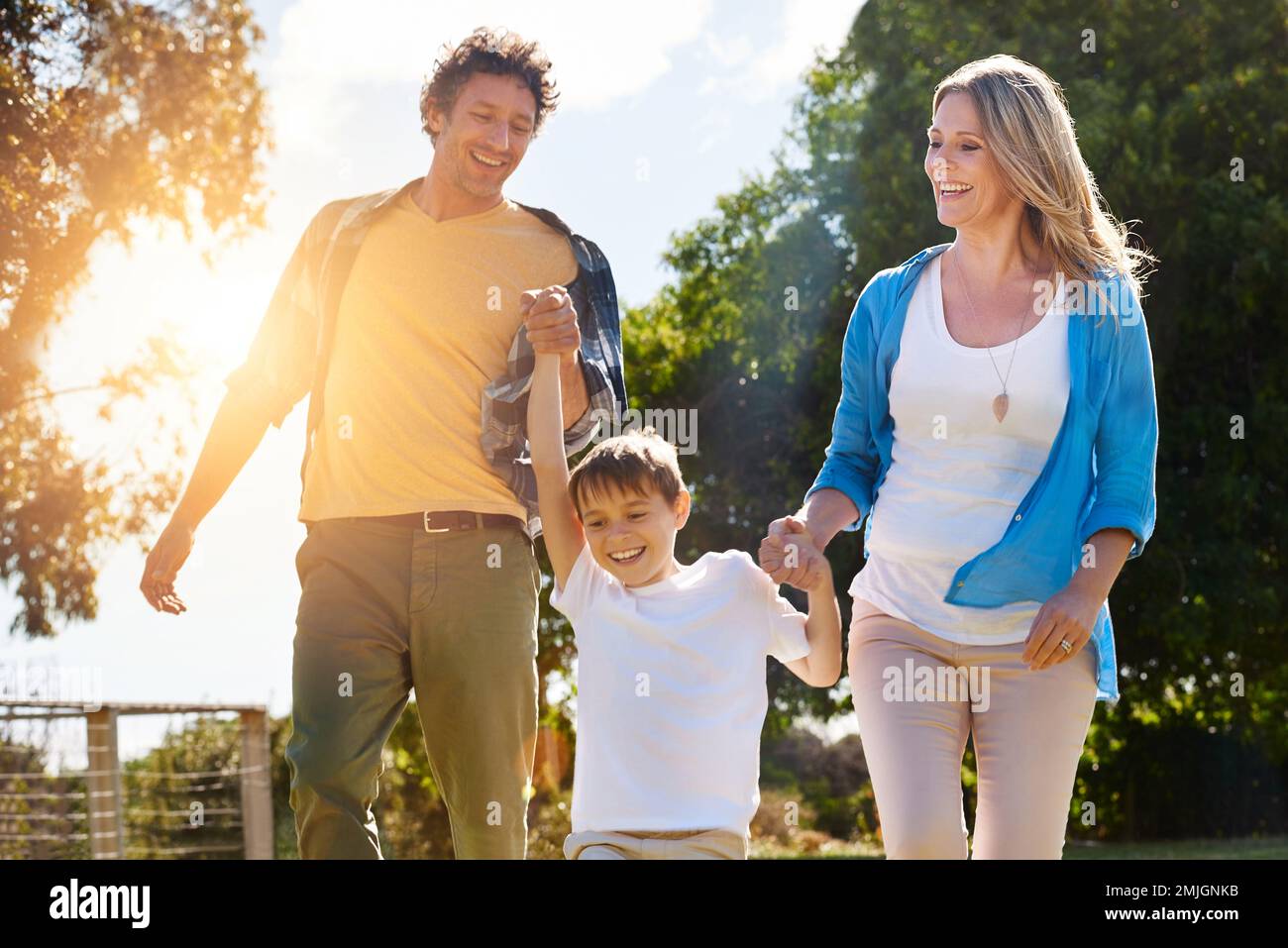 Seeing them happy is all they ever want. a happy family spending time together outdoors. Stock Photo