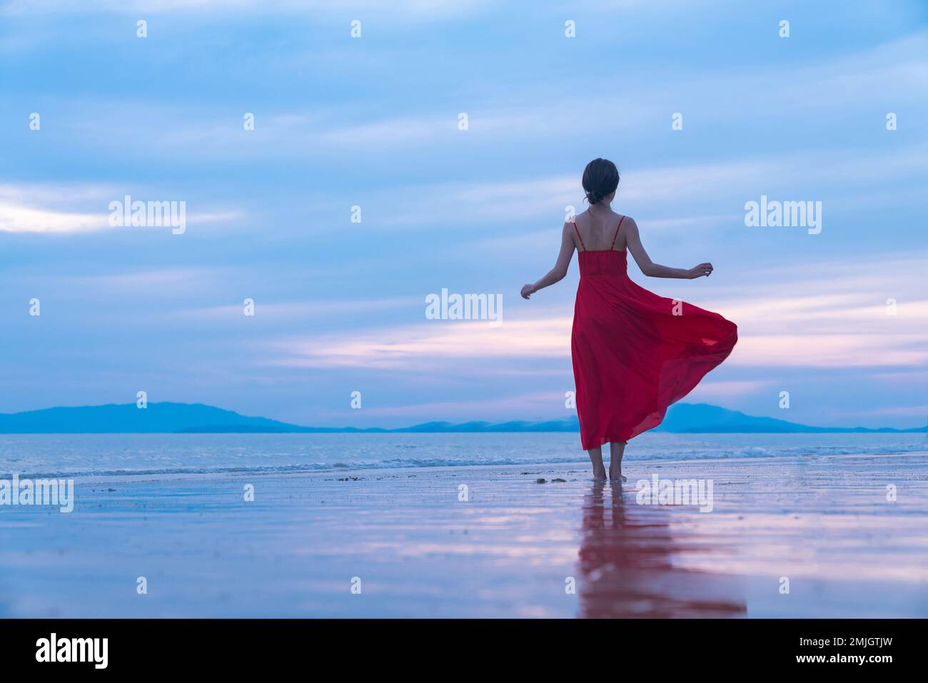 Happy young woman on the beach Stock Photo - Alamy