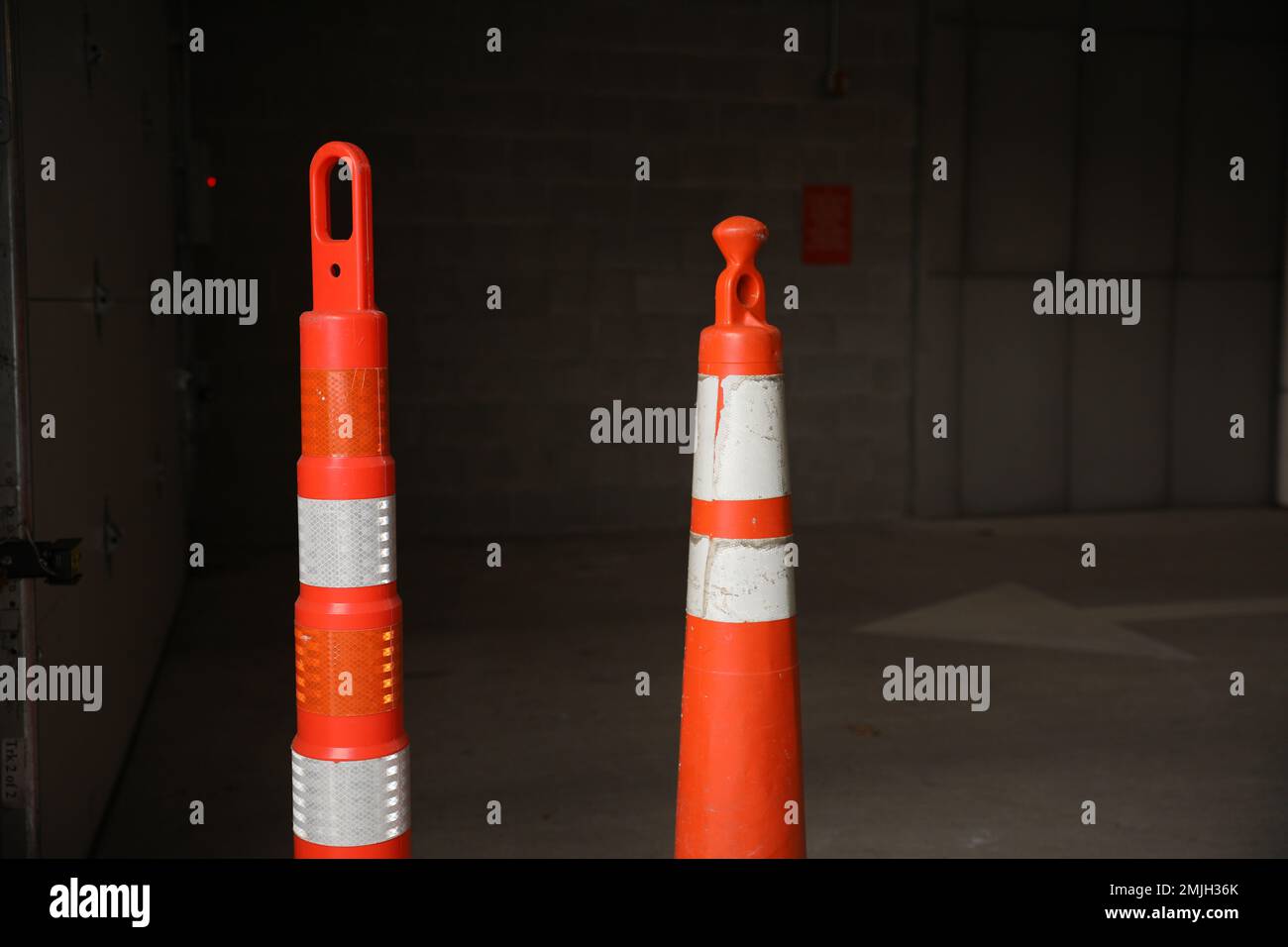 construction cones middle of street roadblock danger orange Stock Photo