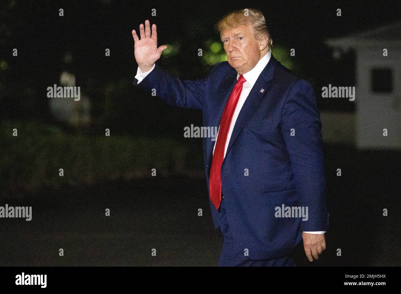 President Donald Trump waves as he arrives on Marine One on the South ...
