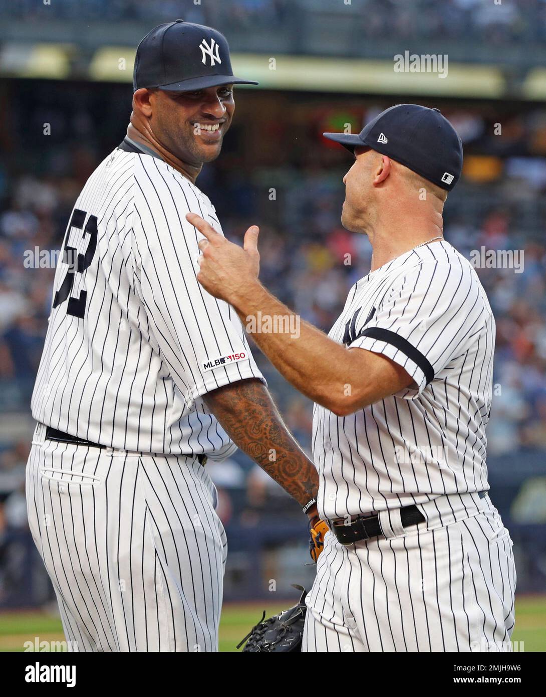 New York Yankees' starting pitcher CC Sabathia (52) laughs and smiles with  Yankees' left fielder Brett Gardner who nade a spectacular catch to rob the  Tampa Bay Rays of a home run