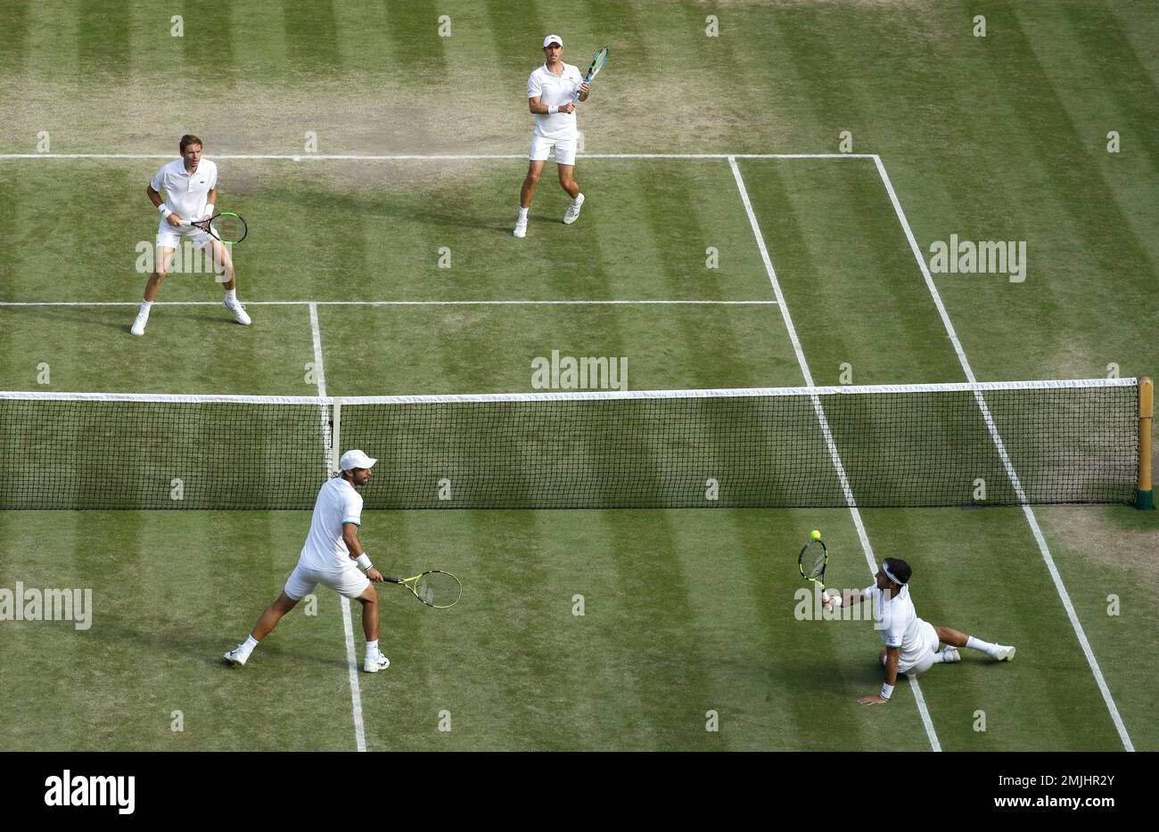 Colombias Juan Sebastian Cabal and Robert Farah, bottom, in action against Frances Nicolas Mahut and Edouard Roger-Vasselin during the mens doubles final match on day twelve of the Wimbledon Tennis Championships in