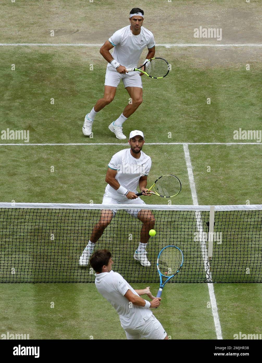 Colombias Juan Sebastian Cabal and Robert Farah, top, in action against Frances Nicolas Mahut and Edouard Roger-Vasselin during the mens doubles final match on day twelve of the Wimbledon Tennis Championships in