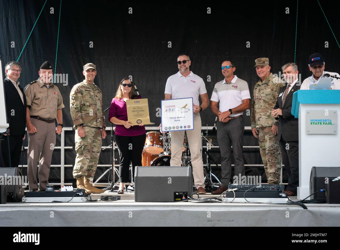 Minnesota National Guard’s Soldier, Capt. Jeffrey Sabatke stands with Think Mutual Bank of Rochester’s Chad DeCook, Larry Guse and Wendy Bacon after accepting the Employer Support of The Guard and Reserve Pro Patria Award on behalf of the company, August 30, 2022, in Falcon Heights, MN. During the Minnesota State Fair's Military Appreciation Day, Employer Support of The Guard and Reserve recognized and honored 23 employers of military families. (Minnesota National Guard Photo by Staff Sgt. Mahsima Alkamooneh) Stock Photo