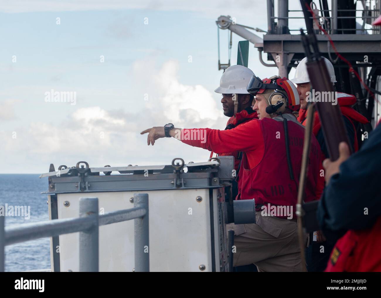 220830-N-LZ839-1018  ATLANTIC OCEAN (August 30, 2022) Wasp-class amphibious assault ship USS Bataan (LHD 5) Sailors discuss procedures during a replenishment-at-sea with the fleet replenishment oiler USNS Patuxent (T-AO 201) on the ship’s flight deck, Aug. 30, 2022. Bataan is underway conducting an Afloat Training Group engineering inspection as part of the basic phase training cycle. Stock Photo