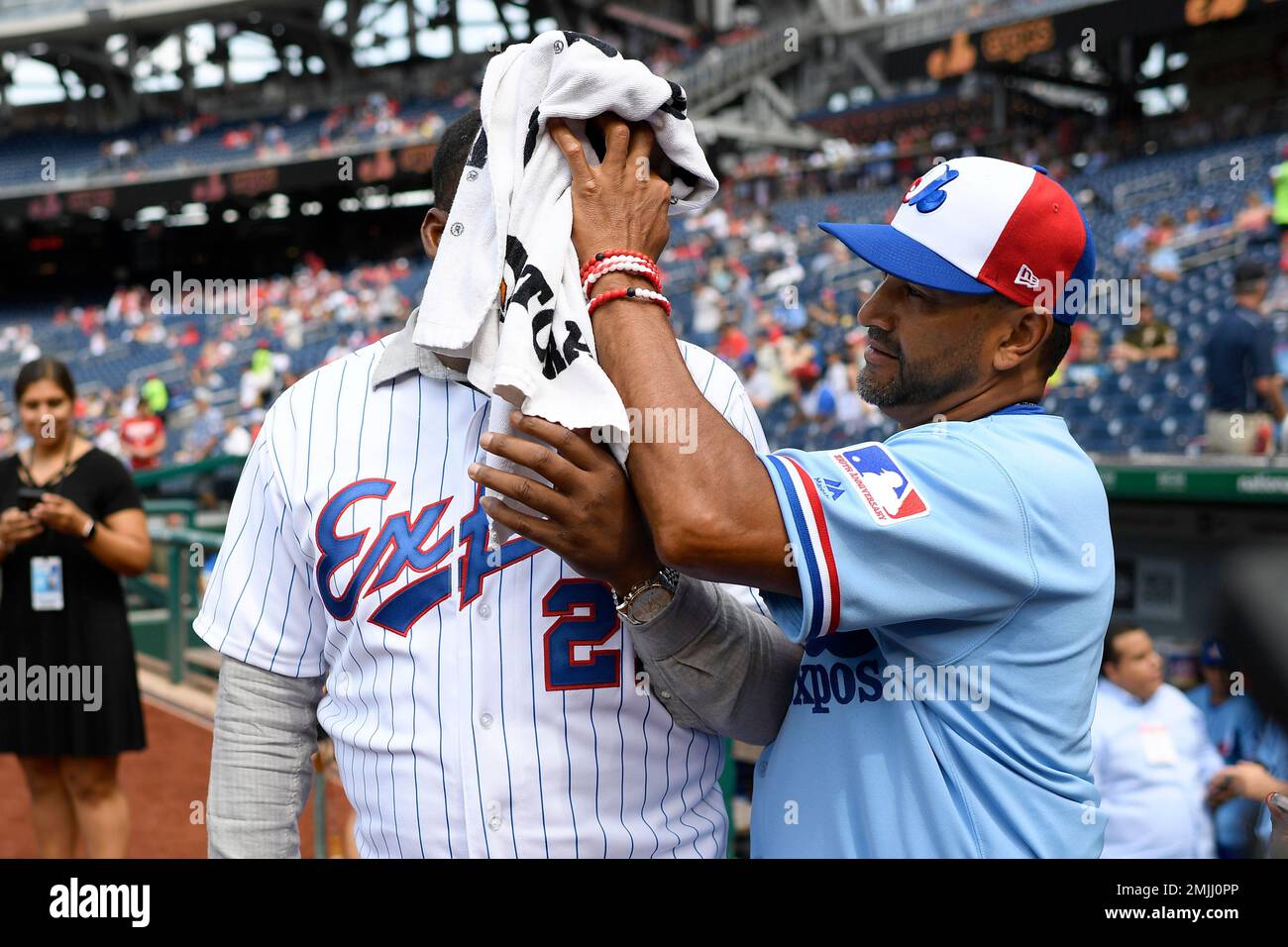 Washington Nationals manager Dave Martinez, right, wipes the face of  Baseball Hall of Famer Vladimir Guerrero, left, with a towel before a  baseball game against the Kansas City Royals, Saturday, July 6
