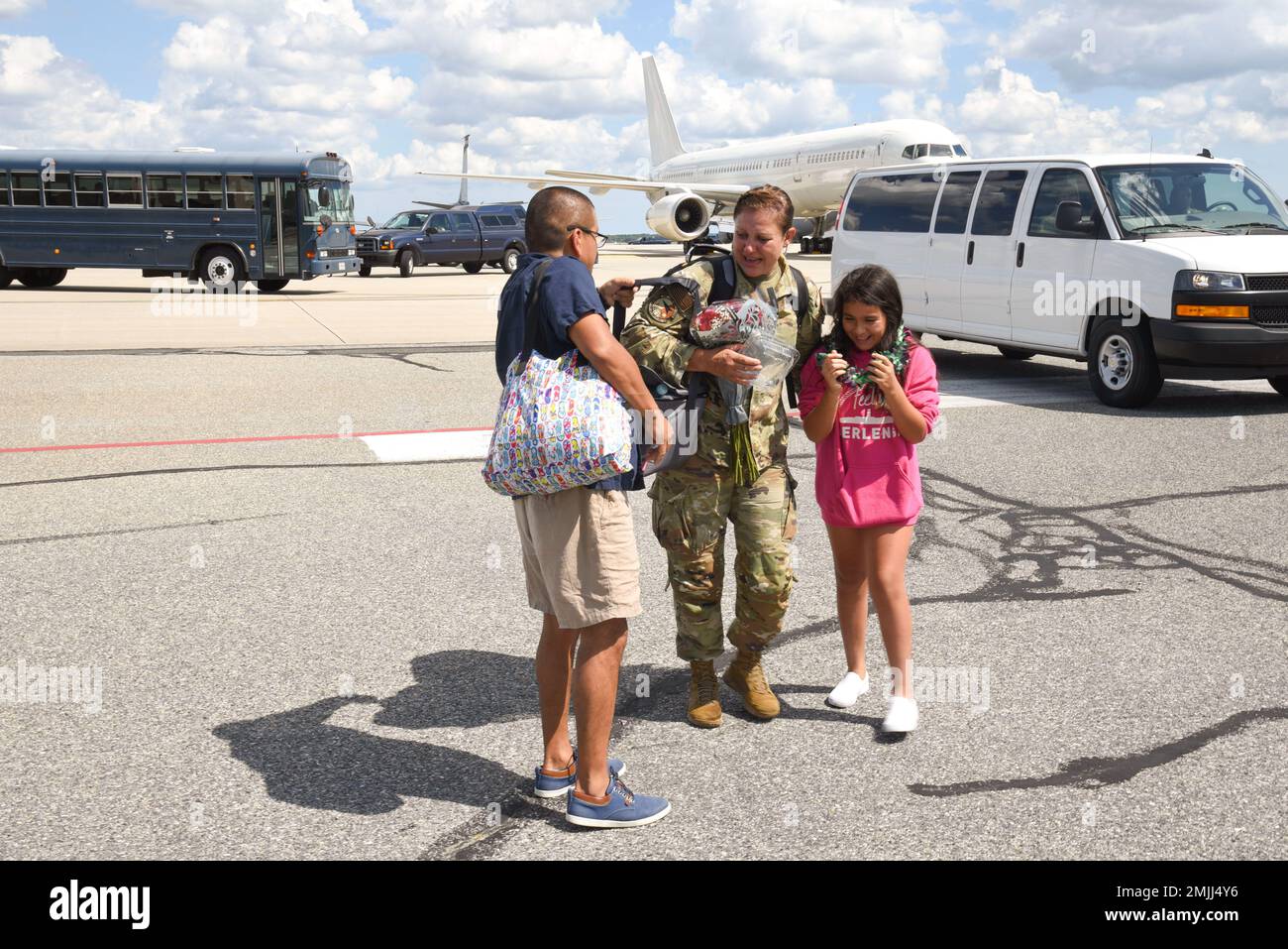 Maj. Lurdes Gil, 108th Aircraft Maintenance Squadron Commander, receives a warm welcome home from her husband and daughter on Aug. 30, 2022 at Joint Base McGuire-Dix-Lakehurst, N.J. Gil was deployed to Andersen Air Force Base, Guam for the previous two months and presented her daughter with a fresh flower lei. Stock Photo