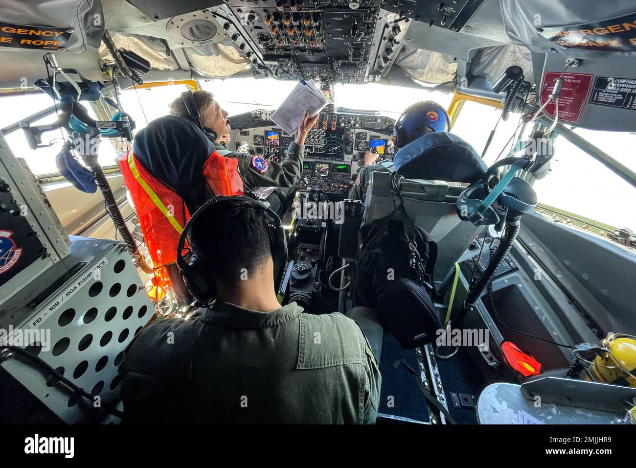 U.S. Air Force Capt. Brian Klazura, (left) a KC-135 pilot from the 93rd Air Refueling Wing, Capt. Edison Mulan (right), KC-135 copilot from the 93rd Air Refueling Wing, and SrA Benny Trevizo, boom operator from the 92nd Air Refueling Wing KC-135s prepare to air refuel with U.S. Air Force F-16 Fighting Falcons from the South Carolina Air National Guard, 157th Fighter Wing during Relampago VII, an exercise in Barranquilla, Colombia, Aug. 30, 2022. The purpose of this exercise is to provide the Colombian Air Force with requested realistic interoperability training as allied countries, under NATO Stock Photo