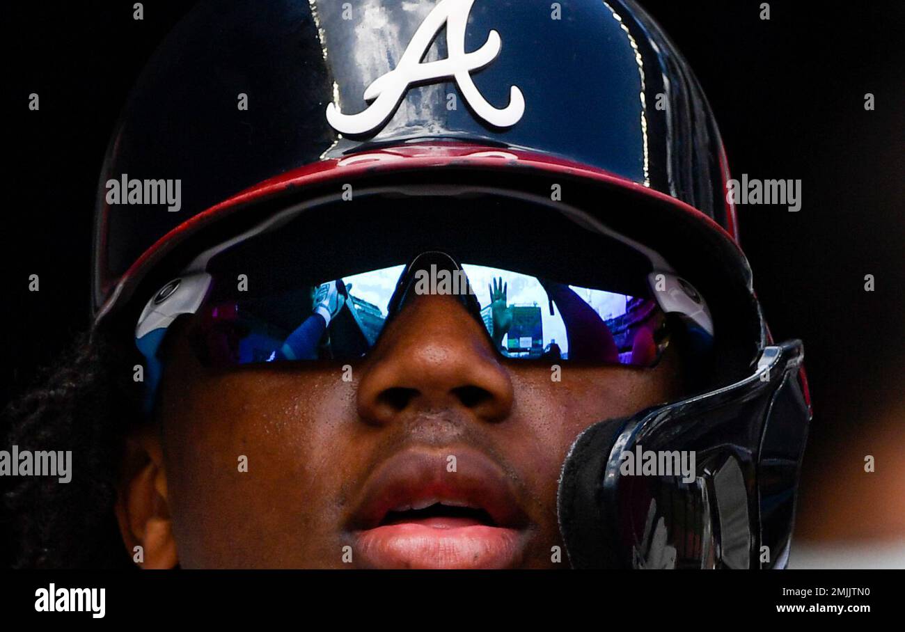 High-fives are reflected in the glasses of Atlanta Braves' Ronald